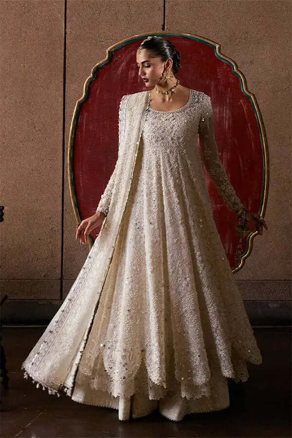 Model showcasing the Zehrell pishwaas with intricate embroidery and a flowing silhouette.