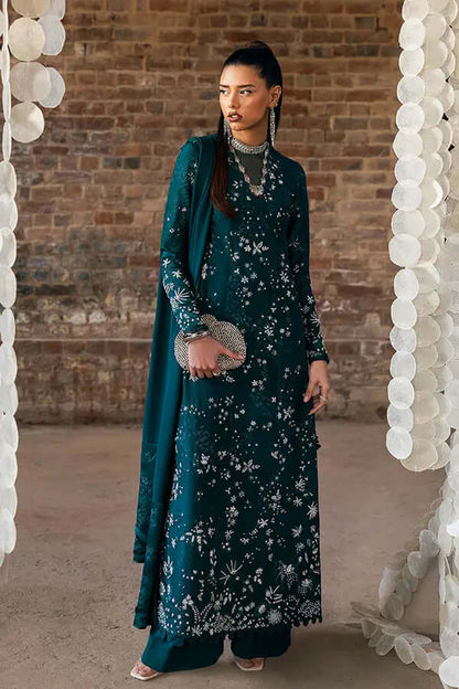 Solara deep green shirt in silk with intricate floral patterns and embroidered details, styled elegantly with fitted sleeves.