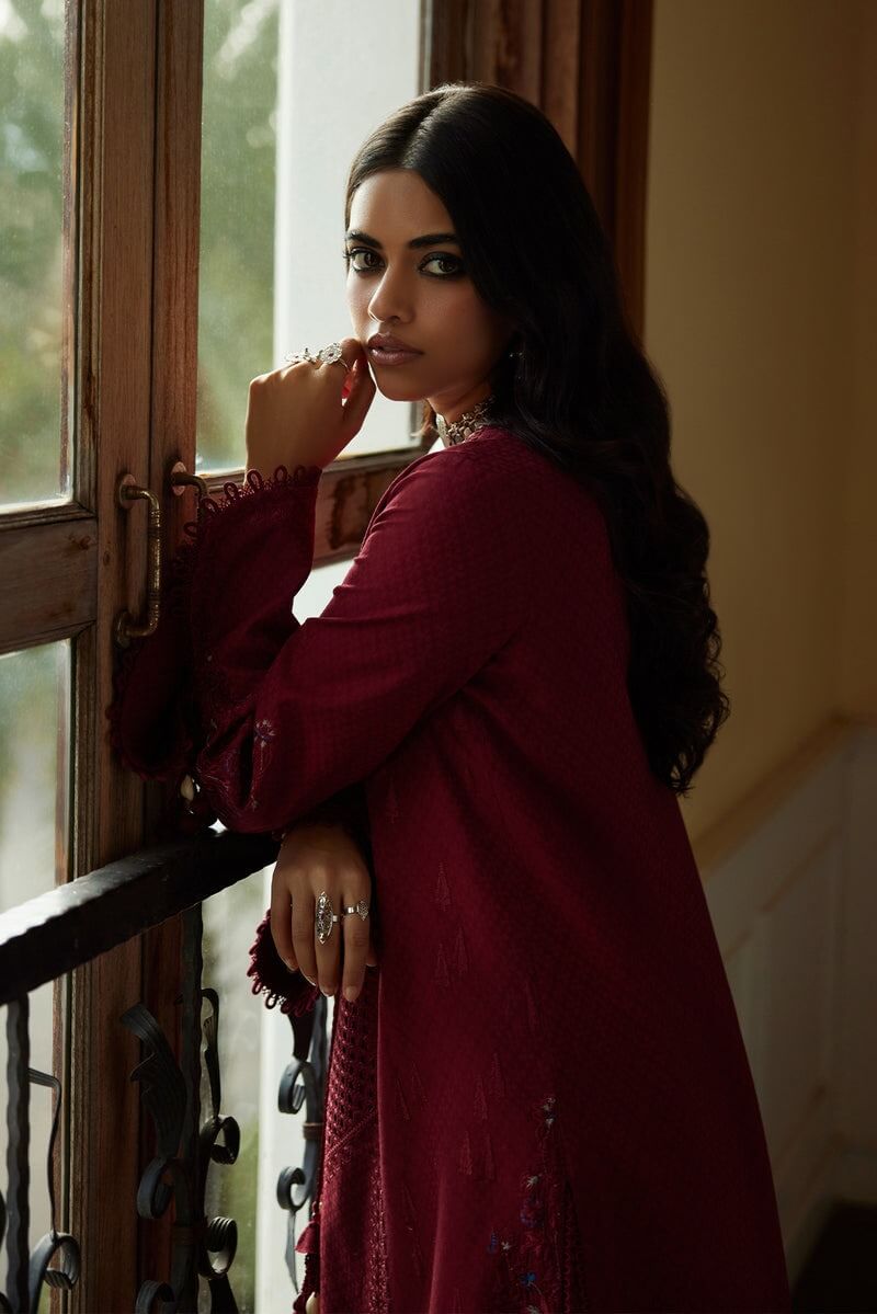Feeha deep red cutwork shirt showcased by model, highlighting elegance with intricate details and stylish aesthetic.