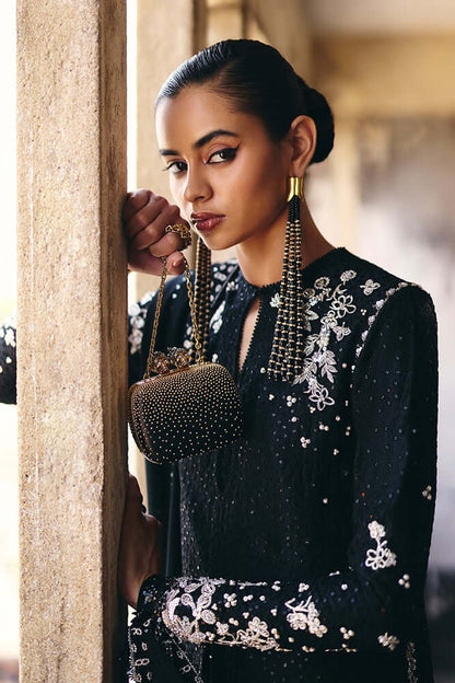 Vivora midnight black silk A-line shirt with embroidery, tassels, and a sparkling purse.