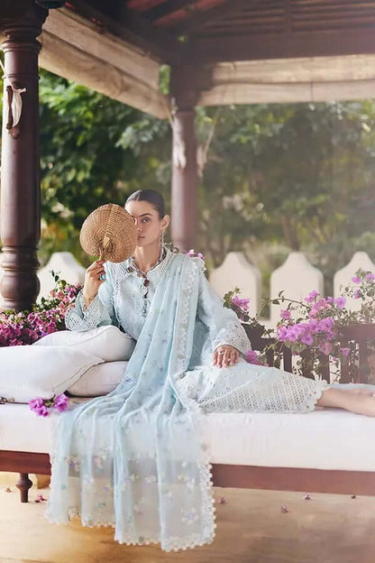 Zarina aqua drop corner shirt with floral embroidery and lace details, styled with a fan in a garden setting.