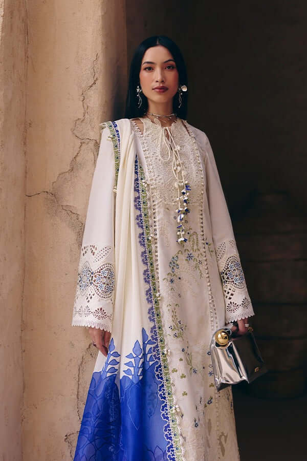 Model wearing Zehra outfit featuring ivory jacquard shirt and blue floral patterns, elegant design for Eid.