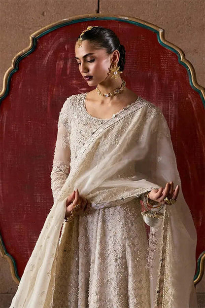 A model in a Zehrell outfit, featuring a white organza pishwaas and elegant embellishments, exuding grace.